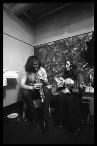 Bonnie Raitt backstage playing guitar, with John Payne (soprano saxophone)