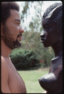 Bill Withers: Withers shirtless and in profile facing an African bust