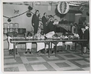 Clients competing in a pie eating contest at Halloween party