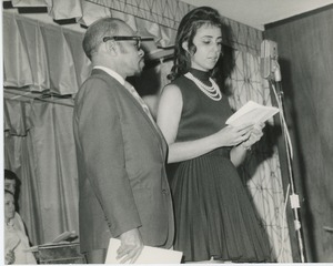 Unidentified man and woman speaking on stage