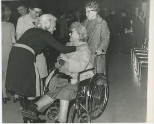 Margaret Milbank Bogert greeting client at Christmas party