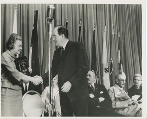 Unidentified woman receiving a president's trophy plaque