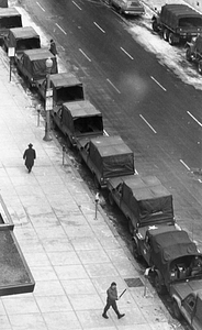 Pedestrians and parked Military Police vehicles on Stuart Street