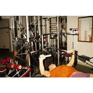 Man works out on an exercise machine in a gym