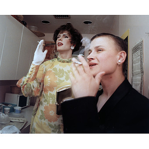 Two cast members from "Fear + Clothing" smoking