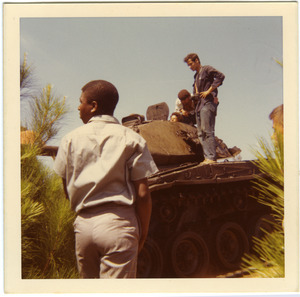 Playa Giron (Bay of Pigs): Brigade members and others atop inactive tank