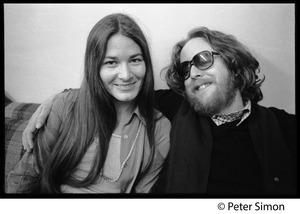 Keith Godchaux, seated on a couch with arm around Donna Godchaux