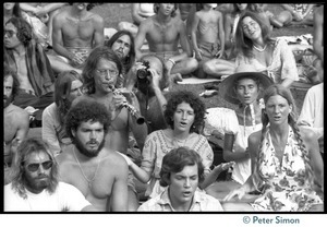 Audience members during Ram Dass's appearance at Andrews Amphitheater, University of Hawaii, one playing an oboe