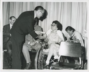 Jeremiah Milbank Jr. handing a gift to Miss Charlotte Cohen at commencement exercises