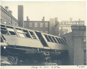 Wreck at Dudley Street, 9:00 am, view from tracks of car lodged in building