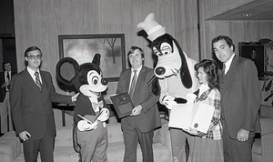 Individuals with Disney characters Mickey Mouse and Goofy