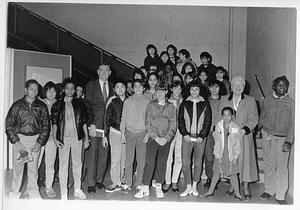 Mayor Raymond L. Flynn posing with Boston Scholl Committee member Rita Walsh-Tomasini and a group of children in the Copley Branch of the Boston Public Library