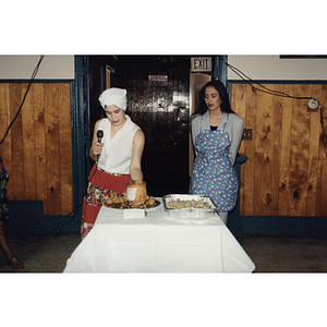 Yaritza Gonzalez and another woman stand next to a table of food