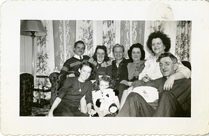 Manny Dias surrounded by friends on couch