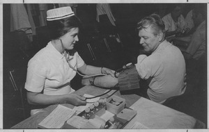Joseph E. Szala having his blood pressure taken.