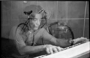 Keyboard player and hand-made bicycle, double exposure