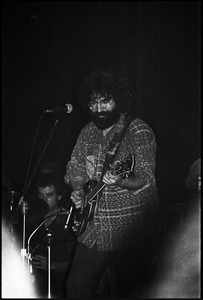 Grateful Dead performing at the Music Hall: Jerry Garcia onstage, playing guitar