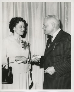 Hermann G. Place handing diploma to an unidentified woman at Institute Day