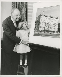 Jeremiah Milbank and a young girl standing in front of a picture of the new ICD building