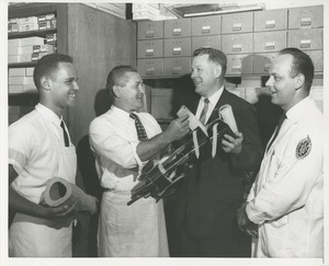 Technicians in the Prosthetics and Orthotics lab show Willis C. Gorthy some prosthetic devices