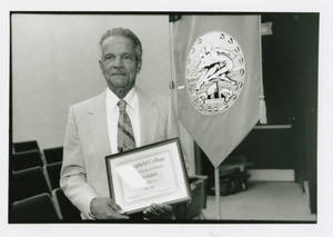 Dr. Walter English holding the Distinguished Professor of Humanics award (1979)