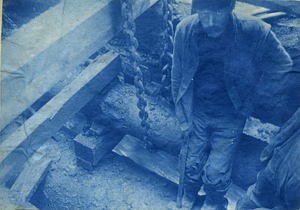 [Worker in trench]