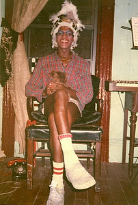 A Photograph of Marsha P. Johnson Sitting in a Chair Holding a Teddy Bear