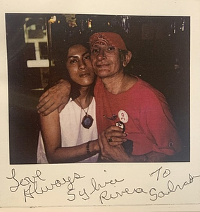 A polaroid of Sylvia Rivera and Melissa with Their Arms around Each Other