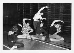 Suffolk University students doing stretching exercises in a physical education class
