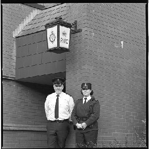 Old RUC lamp at the old RUC station, Banbridge, Co. Down and shots with male and female officers under the lamp