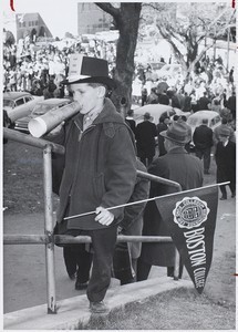 Boy holding Boston College pennant during campus event