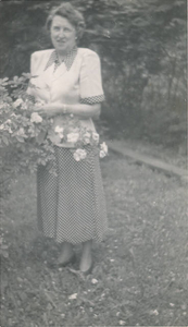 Mom picking roses in her front yard