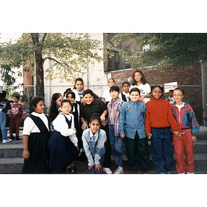 Group portrait of elementary school children standing outside in a park.