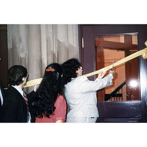 Jovita Fontanez cuts the ribbon at a ceremony celebrating the near-completion of Taino Tower.