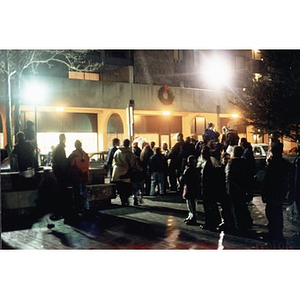 Crowd gathered outside at night to see Santa Claus near the Villa Victoria arcade.