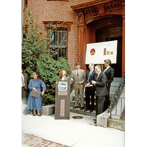 Woman speaking at a press conference to announce details of the rehabilitation project that would create affordable housing units known as Residencia Betances.