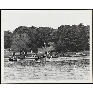 A Large group of youth and adults canoeing on the Charles River