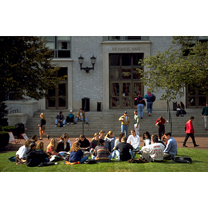 Students sitting on grass in front of Richards Hall