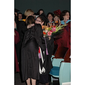 Students present faculty member with flowers at School of Nursing convocation