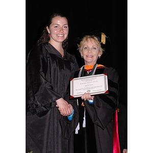 Dean Carole Kenner presents an award to Rebecca Ward at the School of Nursing convocation ceremony