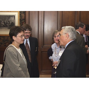 Four people talk at gala dinner