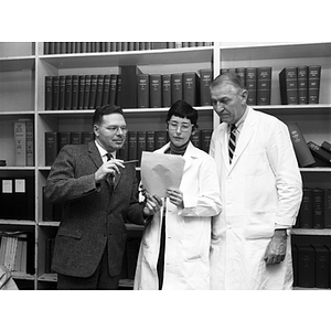 Frank Truesdale (left), Assistant Dean of Lincoln College, reviewing data results with a professor and student from the chemical/biological technology program