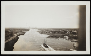 A steamship moves down the Cape Cod Canal toward the railroad bridge