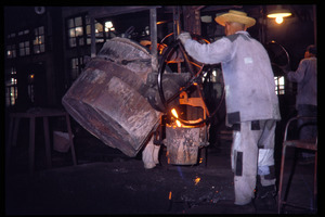 Shanghai tractor building factory: worker pouring iron into mould