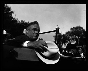 Franklin Delano Roosevelt riding in his Ford Phaeton convertible