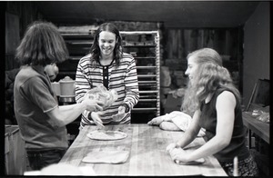 Sammy Wolf, Nick Carson, and Julie Howard (l. to r.) working in commune bakery