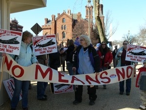 Protesters on the National Mall to march against the War in Iraq, near the Smithsonian building, holding a banner reading 'No means no'