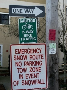 Signage along Commercial Street for emergency snow route and two-way bicycle traffic, Provincetown