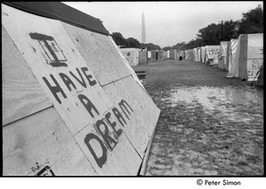 Plywood 'tent' with 'I have a dream' spray-painted on the side and the Washington Monument in the distance, Resurrection City