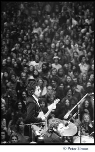 Bob Dylan performing on stage at the Boston Garden with The Band, Levon Helm on drums in the foreground